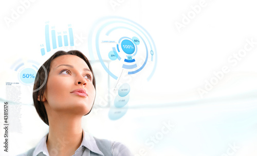 Photo: Young business woman working with innovative virtual interface Young business woman working with innovative virtual interface