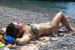 Young woman tanning at beach