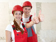 Worker rest on a rubble mountain showing thumbs up in site