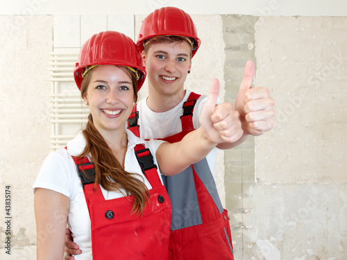 Photo: Worker rest on a rubble mountain showing thumbs up in site Worker rest on a rubble mountain showing thumbs up in site