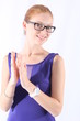 Attractive young woman with eyeglasses clapping her hands