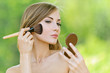 Photo: young woman causes powder to face young woman causes powder to face