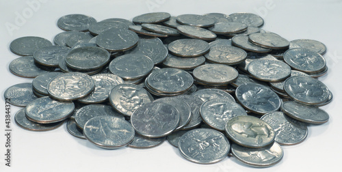 Photo: Pile Of Quarters Coins On Grey Background Pile Of Quarters Coins On Grey Background
