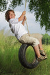 happy boy on swing outdoors