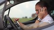 Young businesswoman with tablet and phone in traffic jam