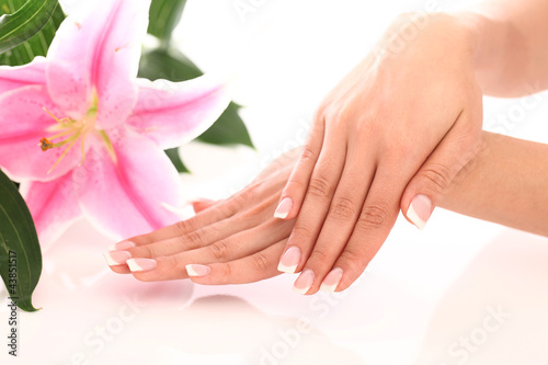 Photo: Beautiful woman hands and lily flower Beautiful woman hands and lily flower