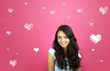 Photo: beautiful young smiling girl against pink background beautiful young smiling girl against pink background