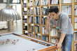 Man looking at a pool table