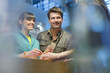 Happy couple standing at a bank counter
