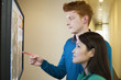 Business people looking at display screen