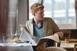 Man sitting in a restaurant and reading a newspaper