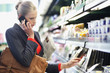 Woman in a supermarket talking on a mobile phone