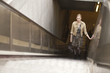 Businesswoman standing on escalator