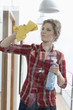 Woman cleaning a glass door