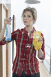 Woman cleaning glass door