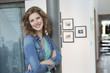 Happy woman leaning against a column