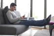 Man holding a credit card and using a laptop