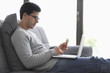 Man holding a credit card and using a laptop