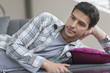 Man lying on a couch and thinking