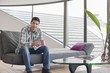 Man sitting on a couch and drinking coffee