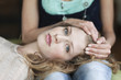 Woman lying on her mother's lap