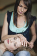 Woman lying on her mother's lap
