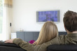 Rear view of a couple watching television