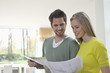 Couple choosing color for their house from a color chart