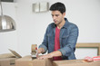 Man taping up a cardboard box