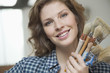 Portrait of a woman holding paintbrushes