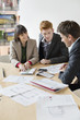 Real estate agent discussing property documents to his clients