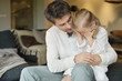 Man holding his cute daughter covering her eyes with hands