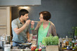 Man asking his mother to taste his cooking