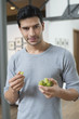 Portrait of a man eating grapes