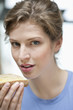 Portrait of a woman eating a bread