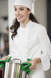 Happy female chef holding a saucepan