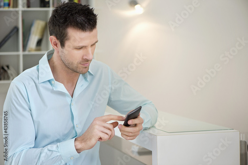 Photo: Man using a mobile phone Man using a mobile phone