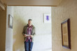 Man using a digital tablet in a corridor