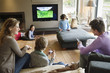 Family using electronic gadgets in a living room