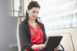 Woman traveling in a bus using a digital tablet