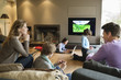 Family using electronic gadgets in a living room