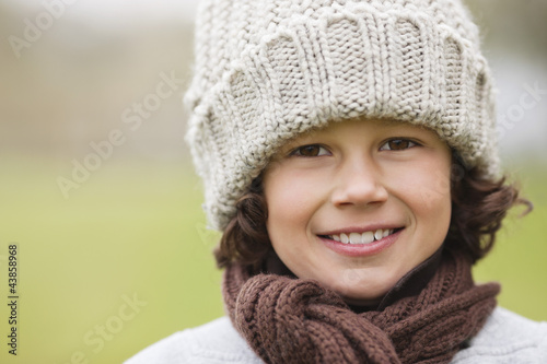 Photo: Portrait of a boy wearing a knit hat and smiling Portrait of a boy wearing a knit hat and smiling