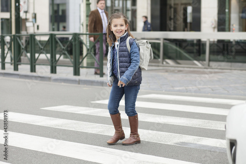 Photo: Schoolgirl crossing a road Schoolgirl crossing a road