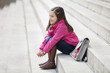 Girl sitting on the steps and smiling