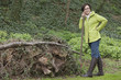 Woman standing with a shovel near a heap of rubbish