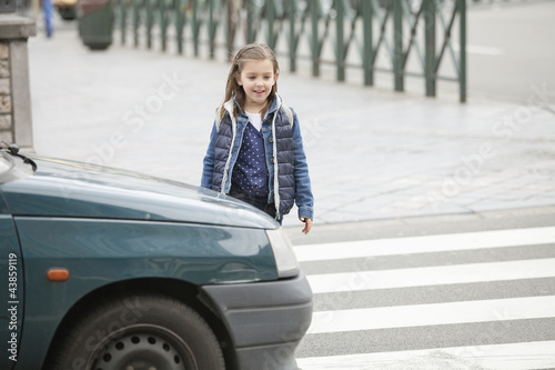 Photo: Schoolgirl crossing a road Schoolgirl crossing a road
