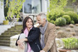 Romantic couple sitting in a garden and smiling