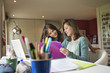 Girl studying with her mother at home