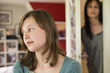 Woman watching her daughter behind the door in the bedroom