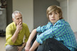 Man sitting with his son looking upset